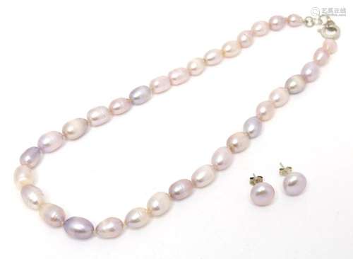 A necklace with matching silver and pearl set stud earrings....