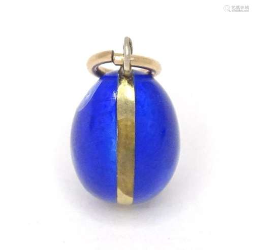 A Swedish silver gilt pendant / charm of egg form with blue ...