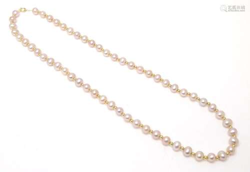 A pink pearl necklace with a 14ct gold clasp and gold spacer...