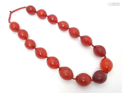 A necklace of vintage cherry amber coloured glass beads. App...