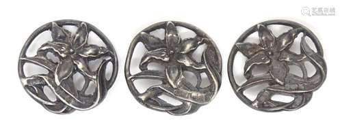 Three Art Nouveau silver buttons with floral decoration. Hal...