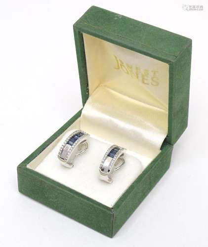 A pair of 18ct white gold earrings set with sapphires and di...