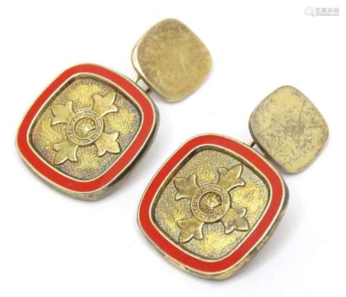 A pair of silver gilt cufflinks with red enamel detail and m...