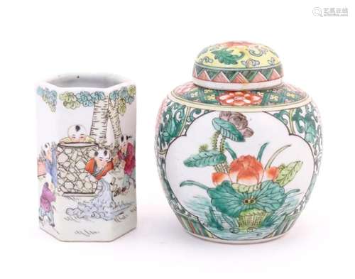 A Chinese ginger jar decorated with flowers and foliage. Tog...