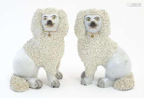 A pair of Staffordshire pottery models of seated Poodle dogs...