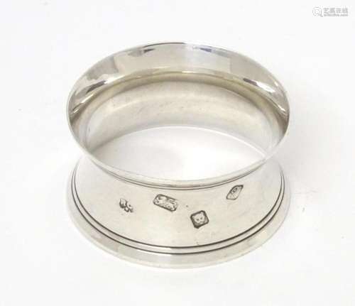 A silver napkin ring hallmarked London 1971, maker William C...