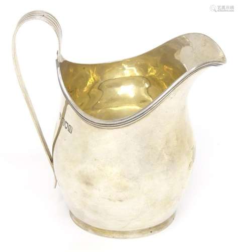 A silver jug hallmarked London 1915, maker C. S. Harris &...