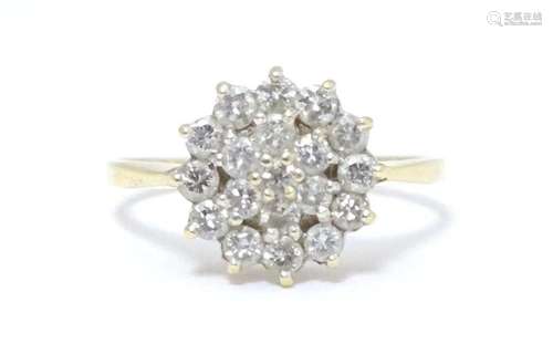 An 18ct gold cluster ring set with diamonds. Ring size appro...