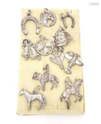 Eleven assorted silver and white metal pendant charms. (11)