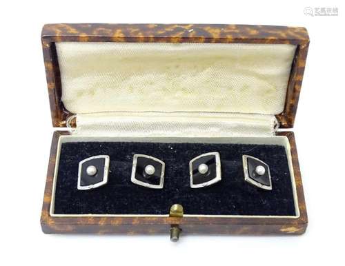 A pair of 18ct gold and platinum cufflinks set with onyx and...