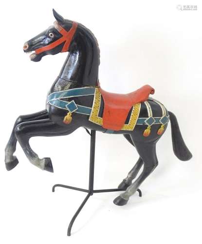 Toy: A late 20thC wooden model of a stylised carousel horse ...