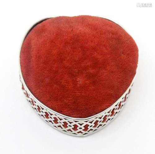 An American pin cushion of heart form with a silver surround...