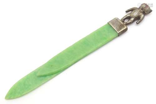 A vintage green Bakelite bookmark / paper clip surmounted by...