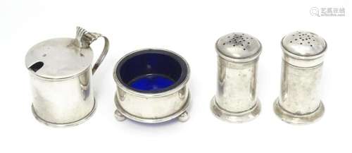 A four piece silver cruet comprising two peppers, salt and m...