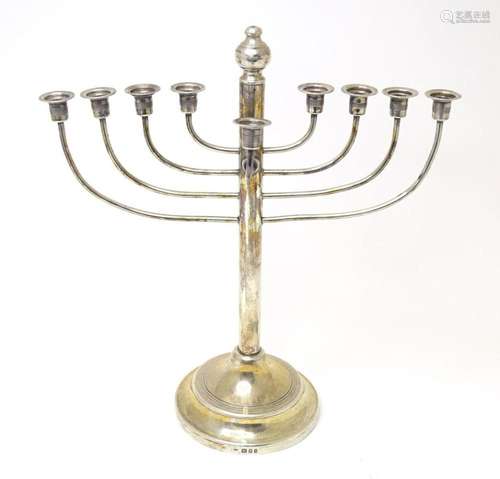 Judaica : A silver Hanukah menorah candelabra with nine bran...