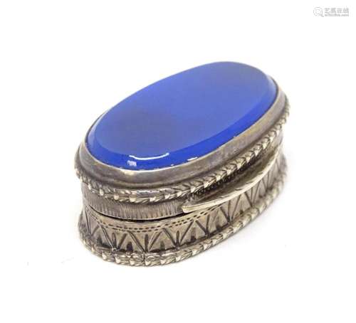 A Continental .800 silver pill box with inset blue detail to...