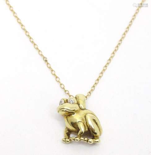 A 9ct gold pendant modelled as a frog on a 9ct gold chain. t...