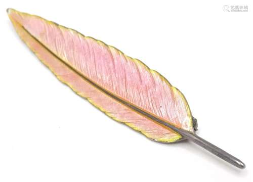 A silver brooch formed as a feather with pink guilloche enam...