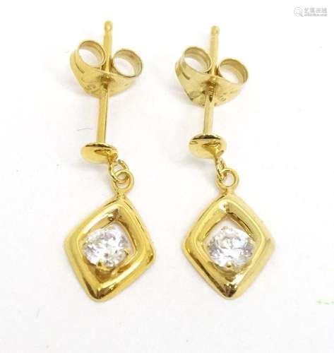 A pair of 9ct gold drop earrings set with white stones. Appr...