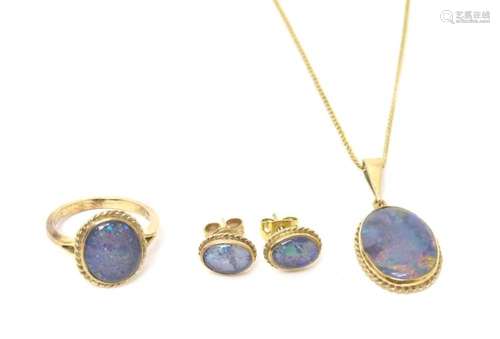 A 9ct gold ring set with opal cabochon, with matching pendan...