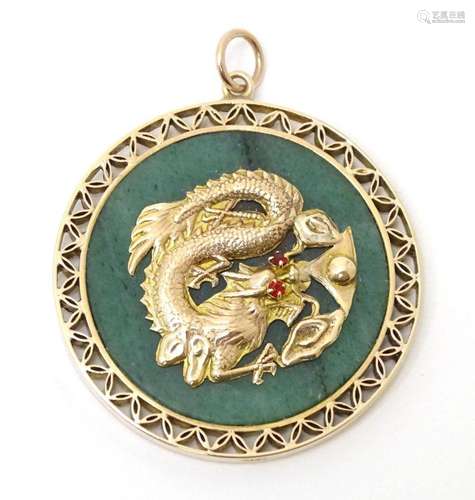 A 14ct gold pendant set with and jade roundel decorated with...