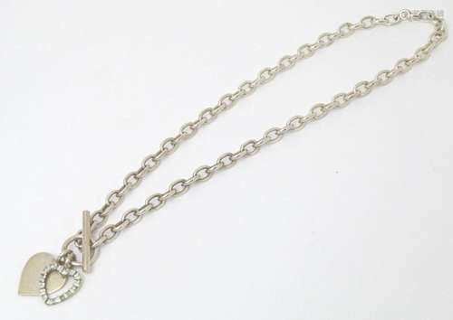 A silver and white metal link necklace with heart charms. Ap...