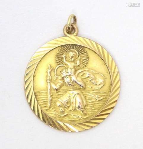 A 9ct gold St Christopher pendant. Approx 1" diameter