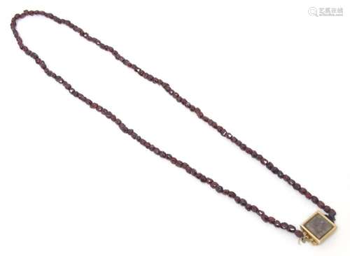 Mourning / Memorial Jewellery: A garnet bead necklace with a...