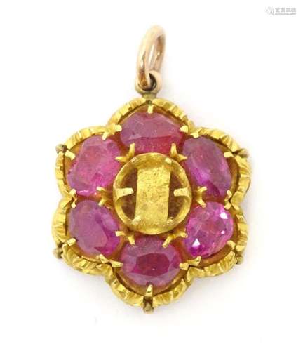 A yellow metal pendant set with 6 rubies. The whole approx 1...