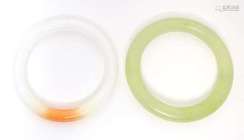 Two oriental hard stone jade coloured bangles.