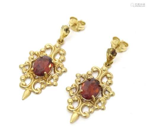 A pair of 9ct gold drop earrings set with garnets. Approx. 1...