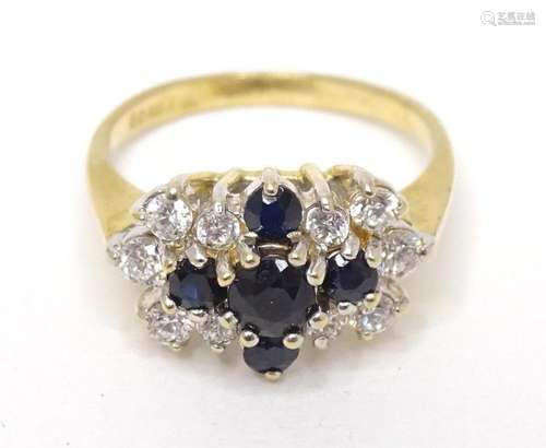 A 9ct gold ring set with white and blue stones. Ring size ap...