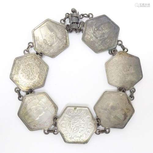 A white metal bracelet formed from 7 Egyptian hexagonal coin...