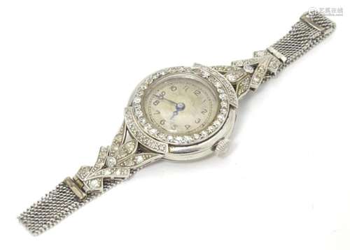 A platinum and white metal ladies wrist watch set with a pro...