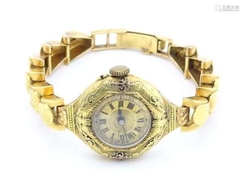 A ladies wristwatch with 18ct gold case and strap. Case appr...