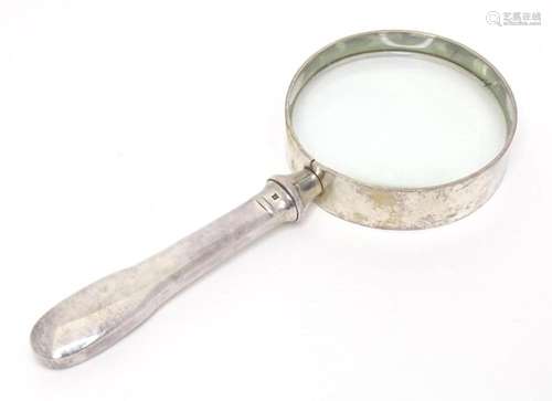 A magnifying glass with silver plate handle by Christofle. A...