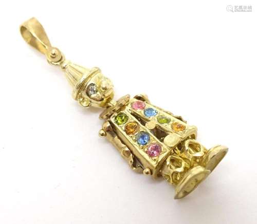 A 9ct gold pendant formed as an clown with articulated limbs...