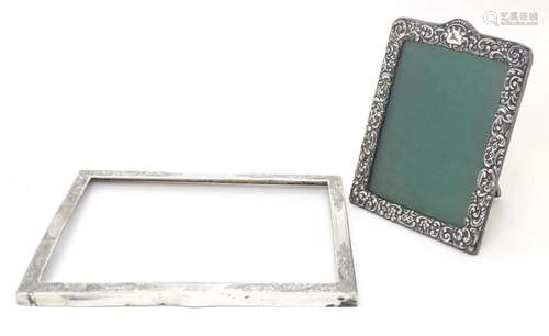 An easel back photograph frame with embossed silver surround...