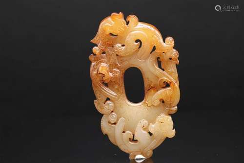 A White Jade with Russet Skin Shield-Form Pendant, Han Dynas...