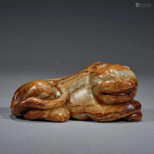 A Celadon and Russet Jade Carving of a Tiger, Qing Dynasty (...