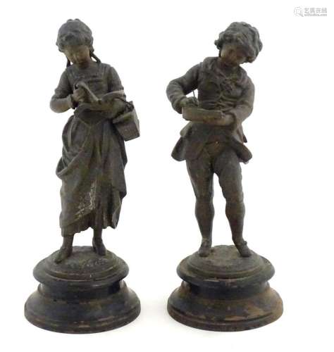 A pair of 20thC cast figures depicting 19thC children, one a...
