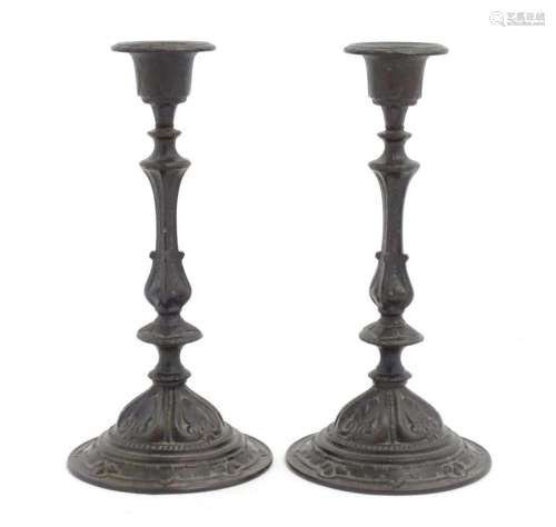 A pair of 19thC German cast candlesticks with scrolling deta...