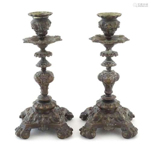 A pair of Victorian cast candlesticks with stylised foliage,...