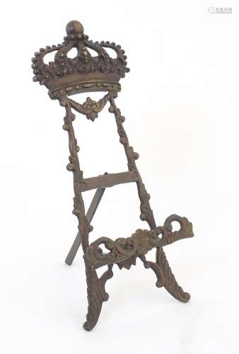 A 20thC cast table top easel with floral, foliate and crown ...