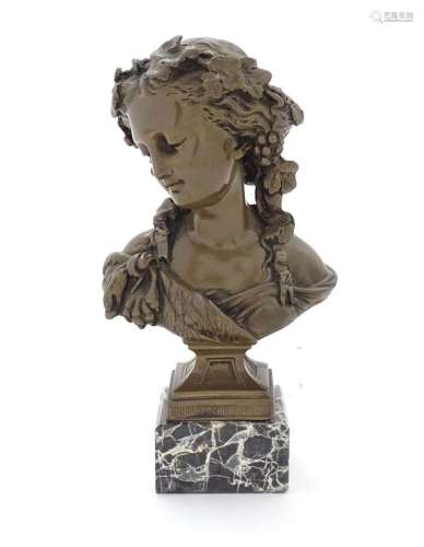 A 20thC cast female bust depicting a Baccante with fruiting ...