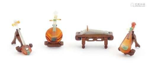 Four Oriental agate models of musical instruments to include...