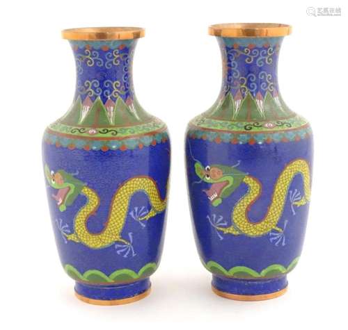 A pair of Oriental cloisonne vases decorated with two dragon...