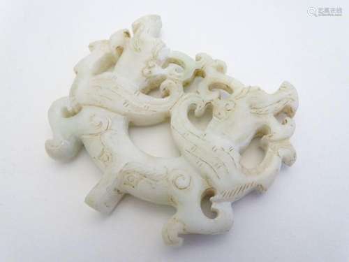 An Oriental carved soapstone pendant / toggle depicting styl...