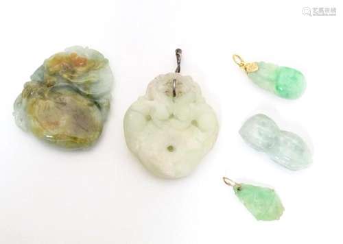 Assorted Oriental carved jade and hardstone pendants. Larges...