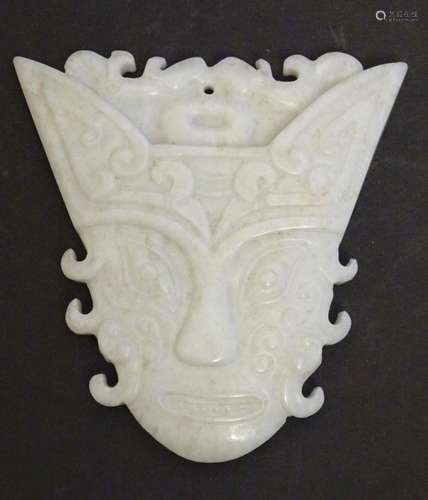 An Oriental carved hardstone pendant formed as a decorative ...